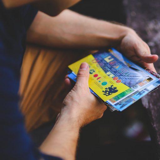 man looking at postcards