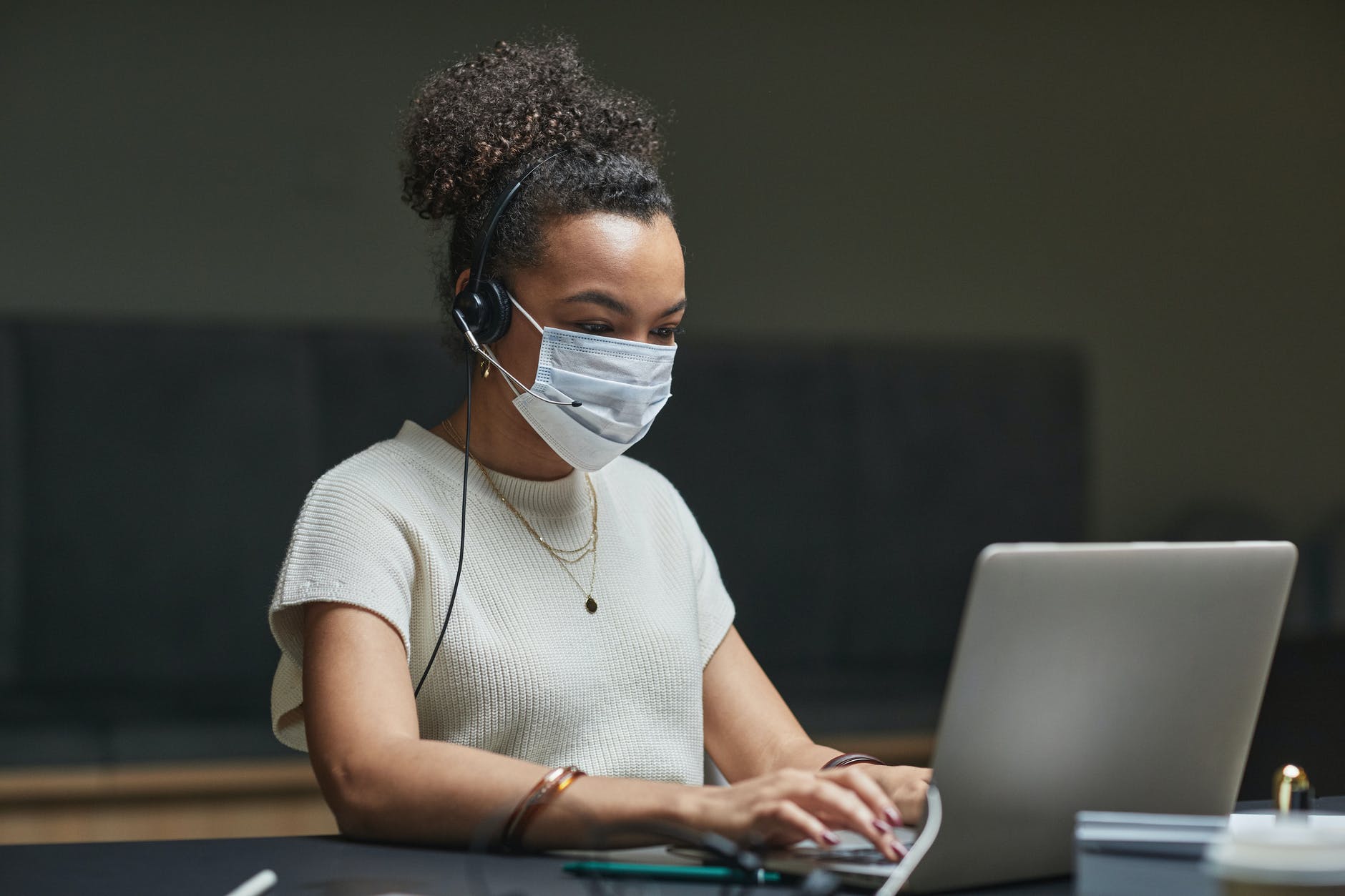 woman with headphones using a laptop