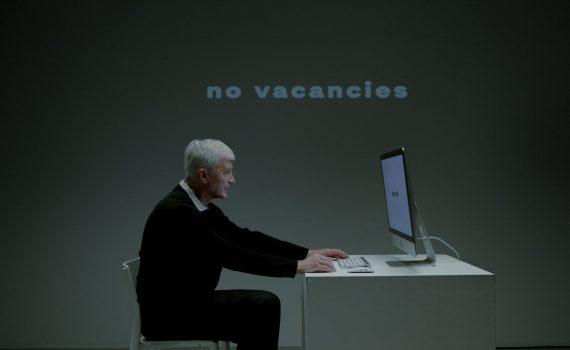 senior adult man sitting in front of pc and writing on keyboard