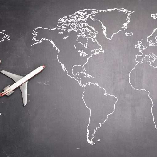airplane over world map on blackboard
