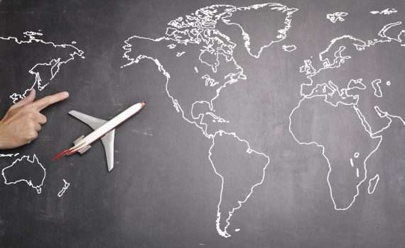 airplane over world map on blackboard